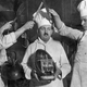 Chocolatiers cut into a giant chocolate egg (black and white photo)